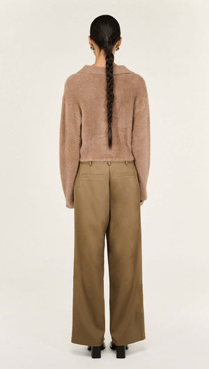 Back view of a model wearing the Mocha Fluffy Knit Polo Jumper with wide-leg trousers.