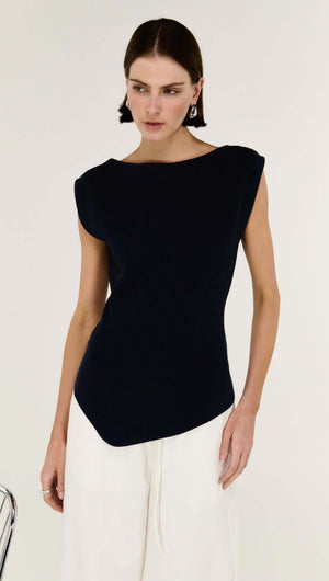 model wearing the Navy Boat Neck Knit Top featuring an asymmetrical hemline and sculpted fit.
