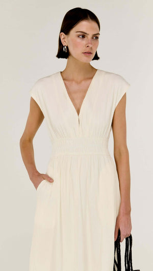 Model wearing the Cream Cotton V-Neck Midi Dress with soft cap sleeves and a defined waist.