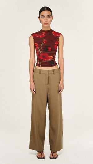 Model wearing a Red Poppy Print Mesh Tank with wide-leg pants, showcasing a bold floral design and elegant fit.