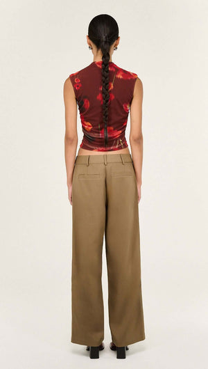 Back view of a model wearing the Red Poppy Print Mesh Tank paired with wide-leg pants.