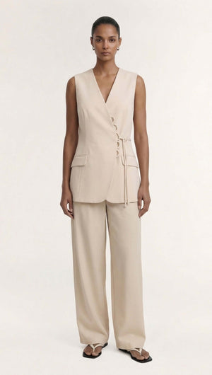 Model wearing a stylish Stone Cotton Wrap Front Vest paired with wide-leg trousers in soft ecru hue.