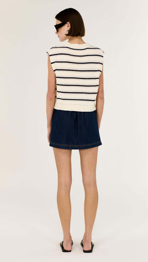 Back view of a model wearing a Striped Cotton Blend Knit Tank paired with a denim skirt.