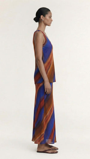 Model showcasing the Sunset Ombre Print Bias Maxi Skirt and matching top, highlighting fluid movement and vibrant colors.