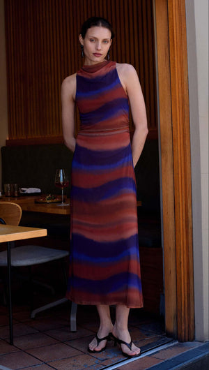 Model wearing a stylish Sunset Ombre Print Sleeveless Mesh Midi Dress in a chic indoor setting.