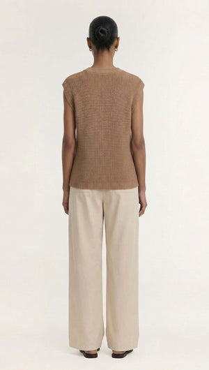 Back view of a model wearing a Taupe Cotton Blend Knit Tank Top paired with wide-leg trousers.