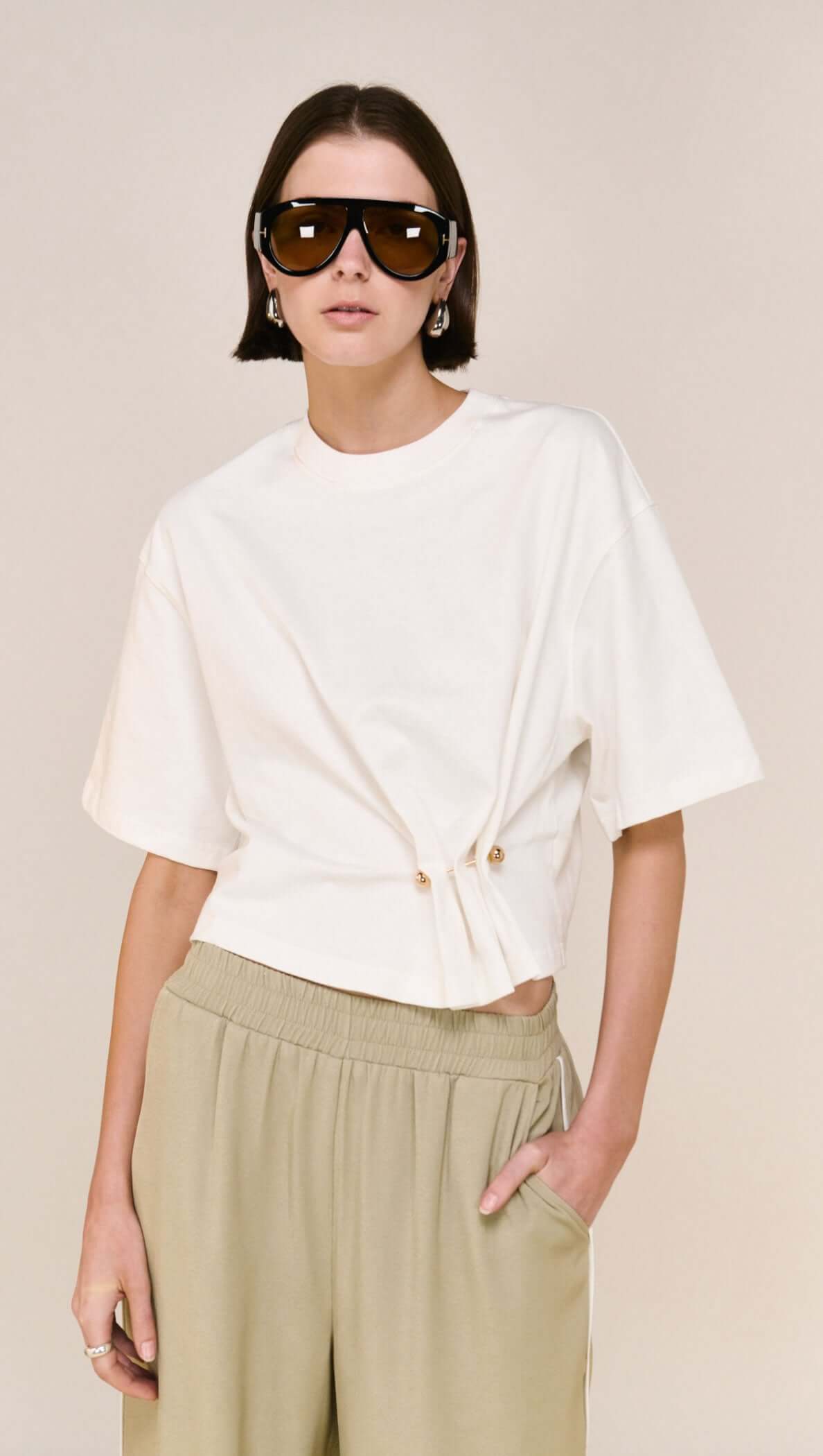 Model wearing the White Cinched Waist Cotton Tee with adjustable drawcord and relaxed fit.