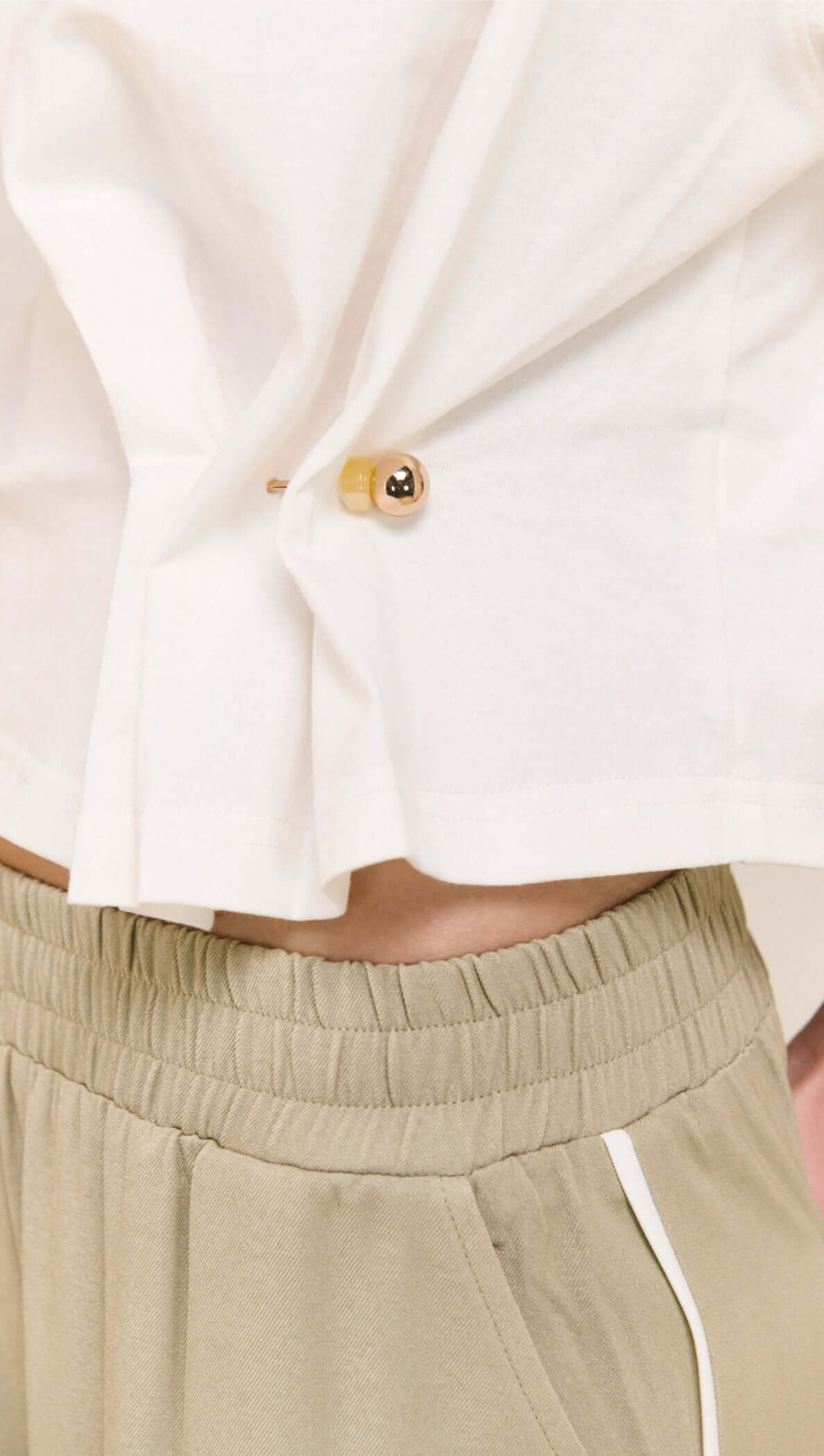 Model wearing the White Cinched Waist Cotton Tee with adjustable drawcord and relaxed fit.