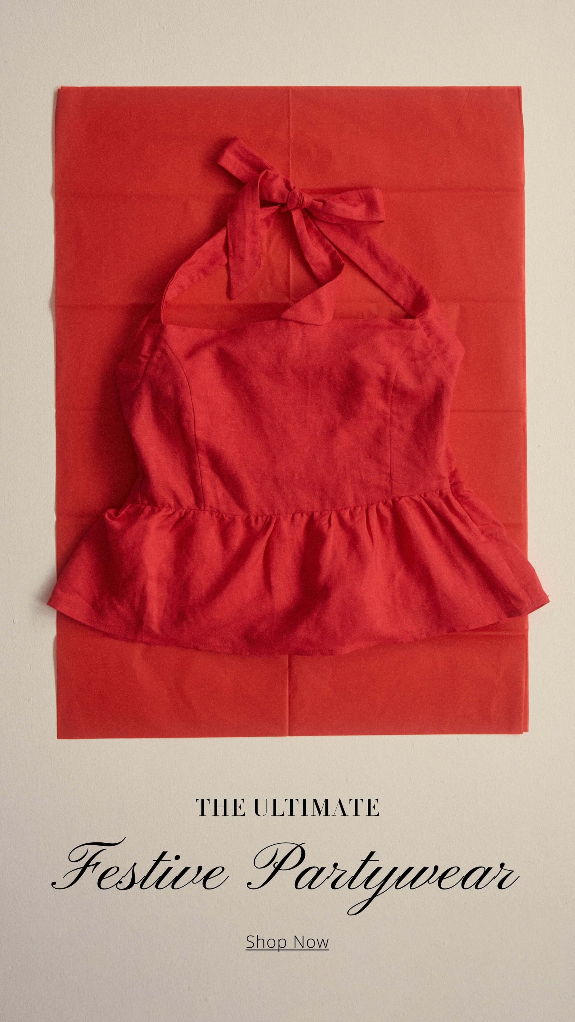 Red halter top on vibrant red background, perfect for festive partywear. Shop the ultimate collection now!