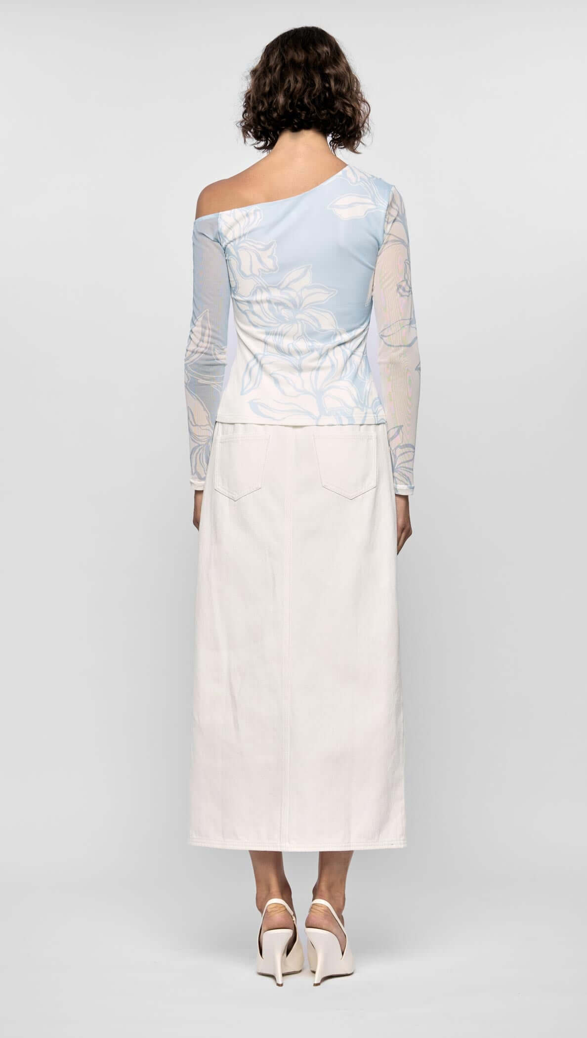 Back view of the Aurora Mesh Top featuring an asymmetric one-shoulder neckline, floral mesh, and a fitted silhouette.