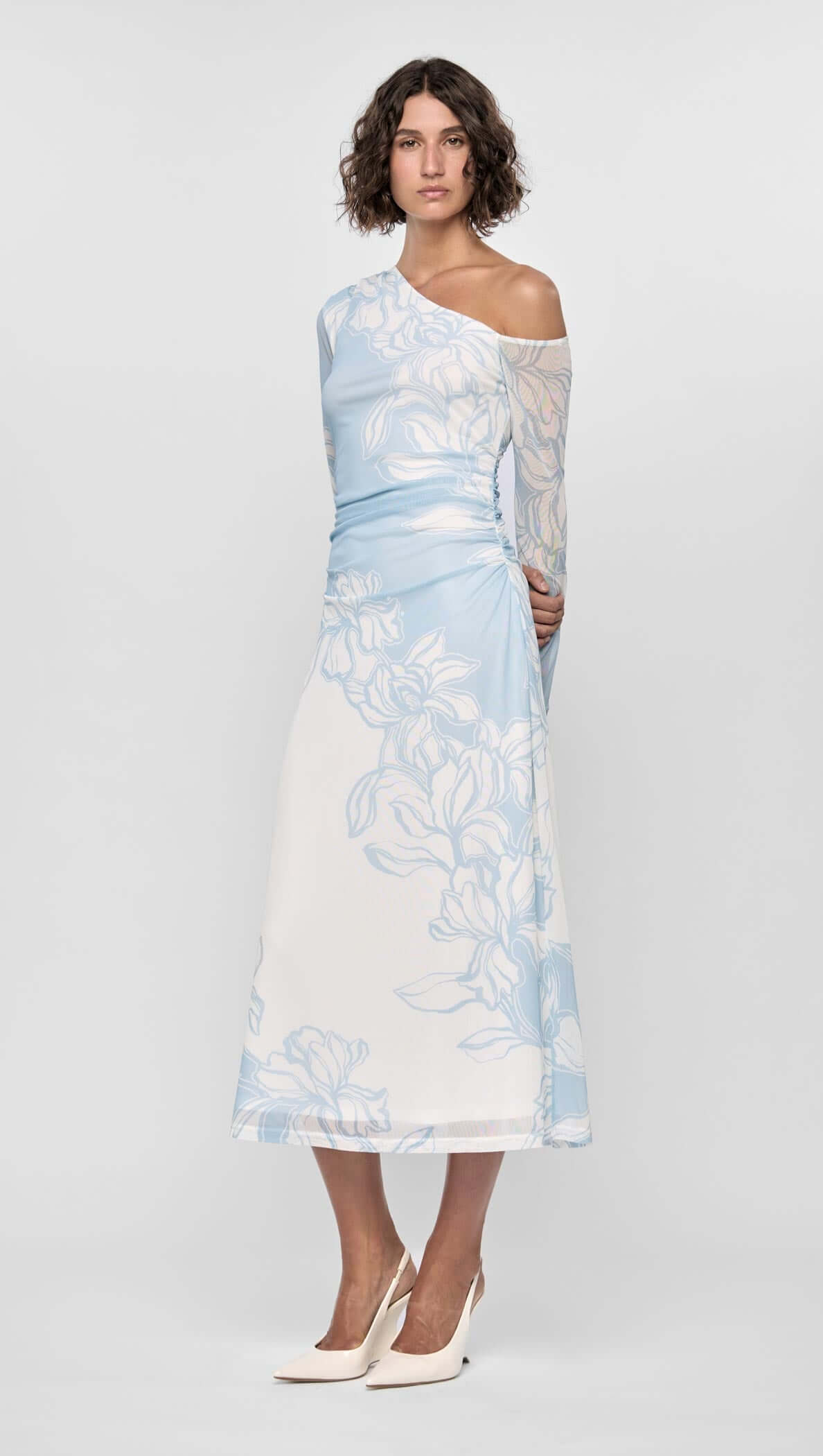 Person wearing Aurora Mesh Midi Dress in blue floral mesh with one-shoulder design and side ruching, showcasing an ethereal look.