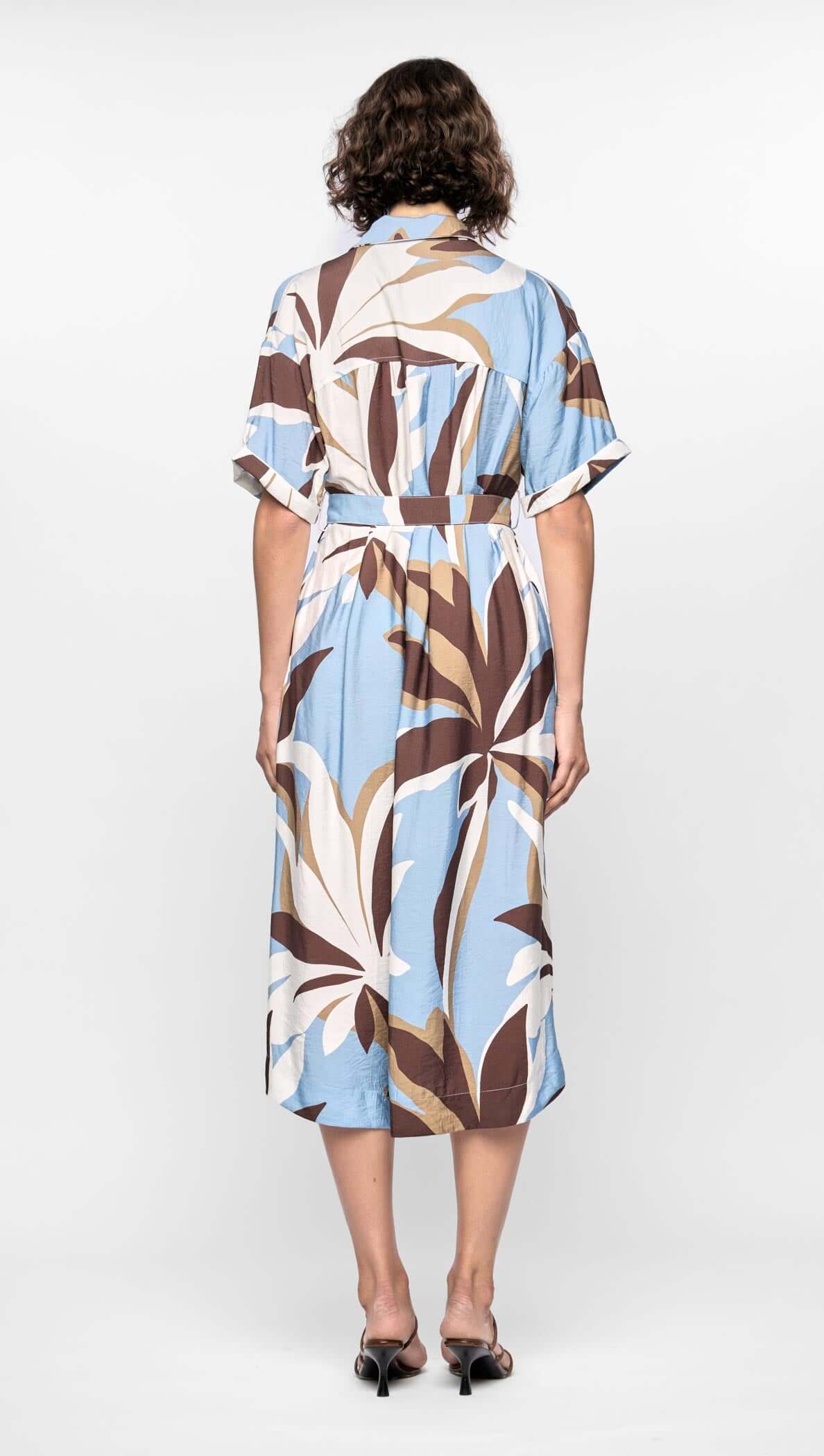 Back view of Maeve Midi Shirt Dress with abstract brown, cream, and blue print, featuring cuffed sleeves and D-ring waist tie.