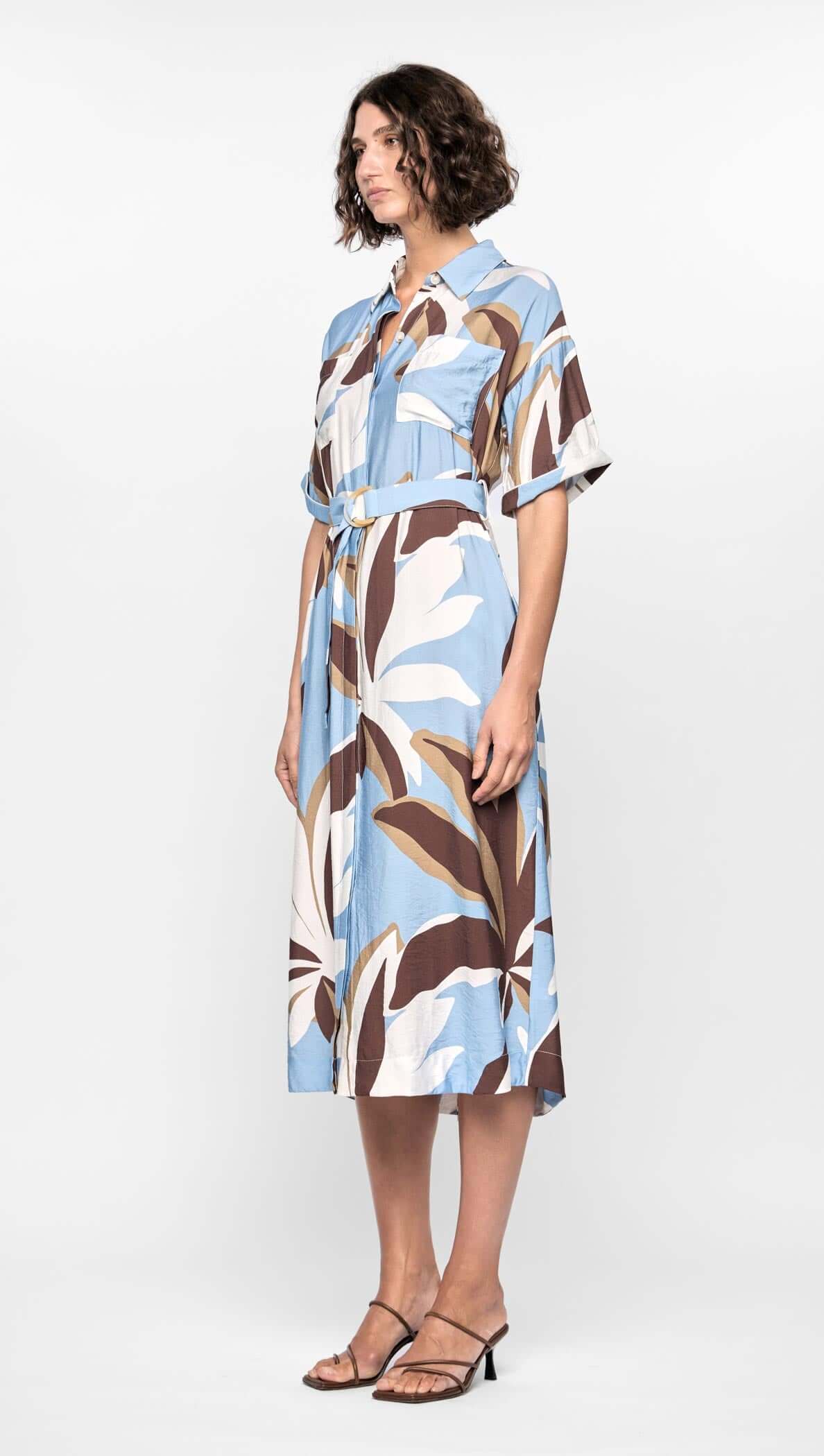 Maeve Midi Shirt Dress featuring an abstract brown, cream, and blue print, short cuffed sleeves, and adjustable D-ring waist tie.