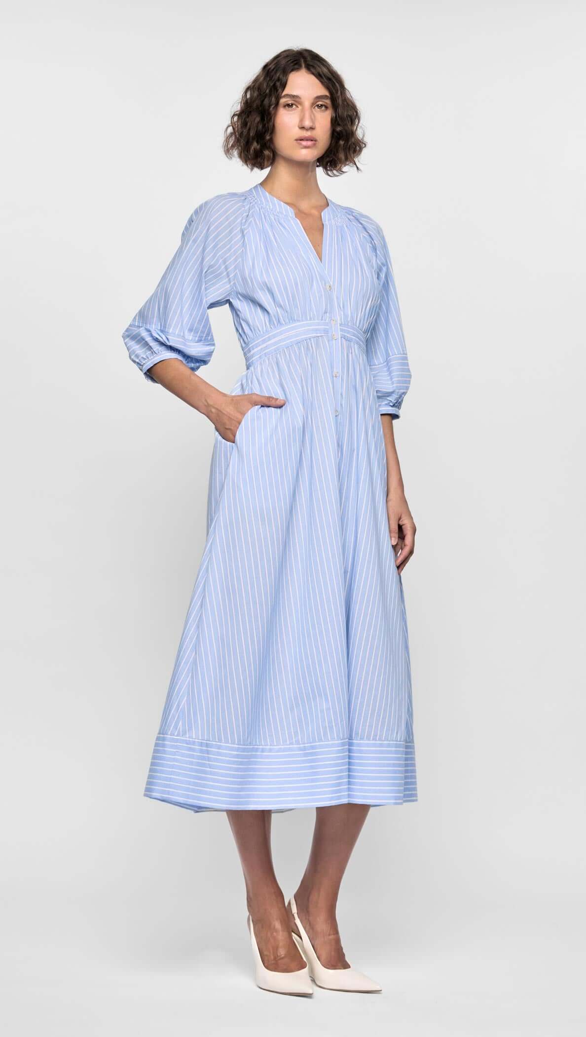 Myra Midi Dress in soft blue stripes with puff sleeves, empire waist, and button-down front, perfect for warm weather styling.