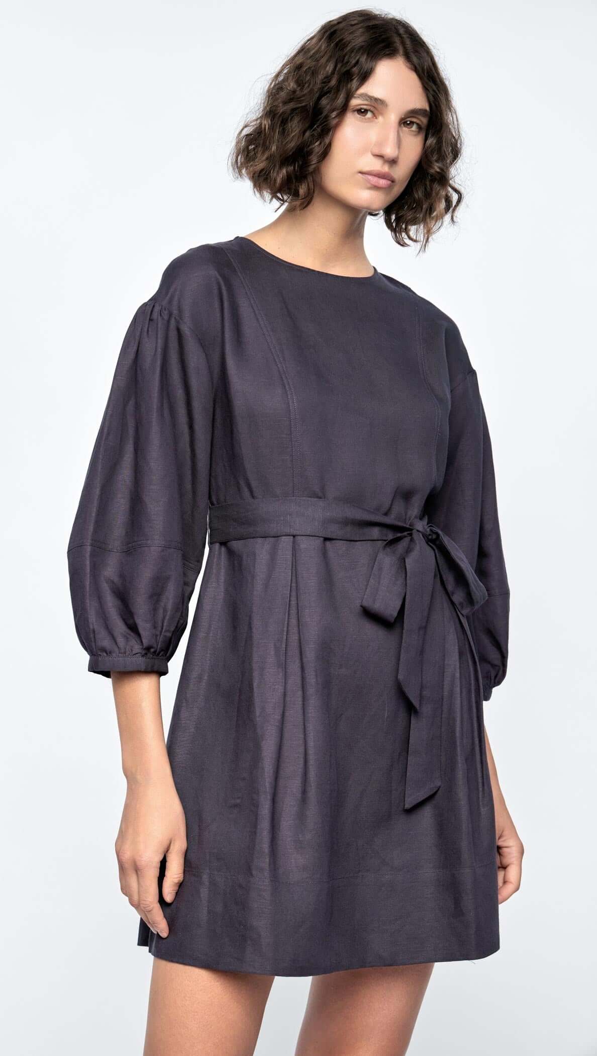 Rhea Mini Dress in navy with 3/4 puff sleeves and removable self-tie belt, featuring a flattering A-line silhouette.