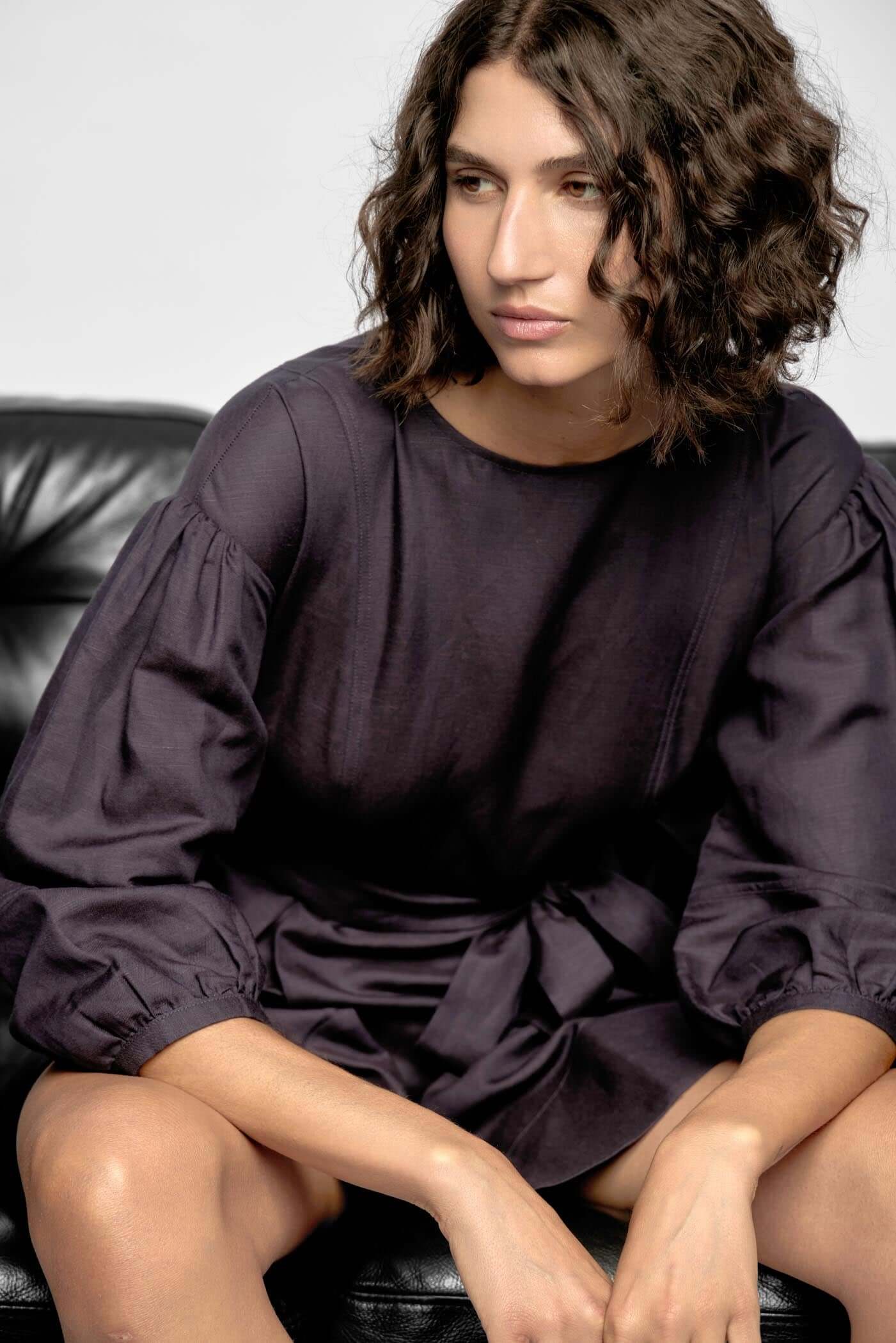 Model wearing the Rhea Mini Dress in navy, featuring voluminous 3/4 sleeves and a flattering A-line silhouette.