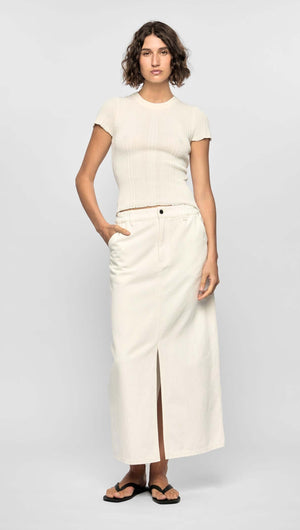 Model wearing the Emmie Denim Midi Skirt in off-white, featuring a high waist and front split for a modern minimalist look.