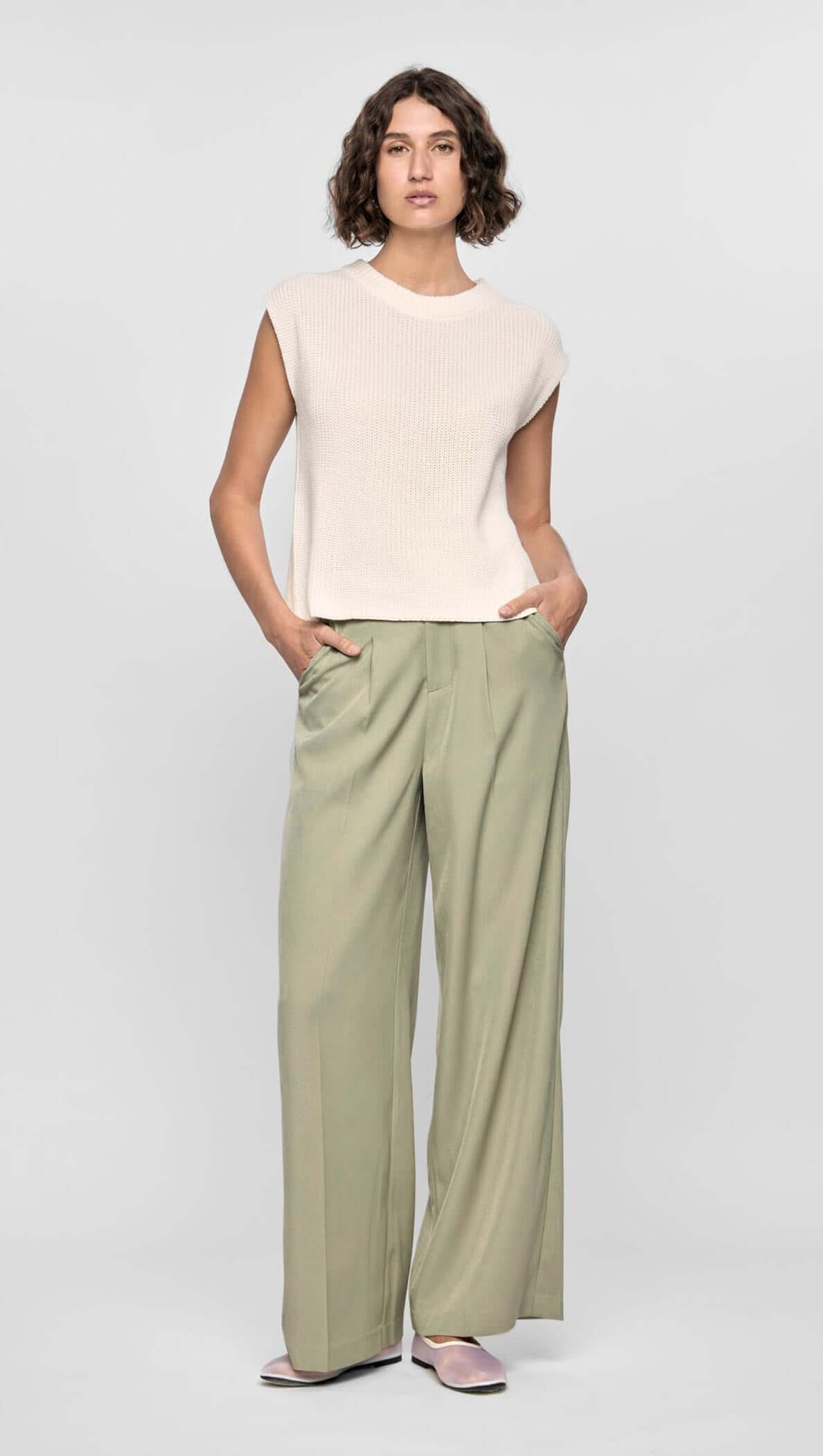 Model wearing the Margot Wide Leg Pant in soft stretch fabric with a relaxed fit, side pockets, and a neutral beige tone.