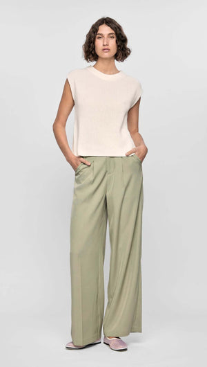 Model wearing the Margot Wide Leg Pant in soft stretch fabric with a relaxed fit, side pockets, and a neutral beige tone.