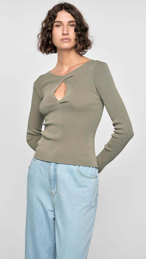 Model wearing the Mira Twist Knit Top in khaki, featuring long sleeves and a twist front detail.