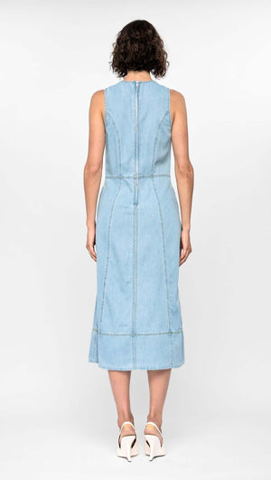 Back view of the Amelia Chambray Midi Dress in light blue, showcasing its fitted bodice, paneled design, and midi-length hem.
