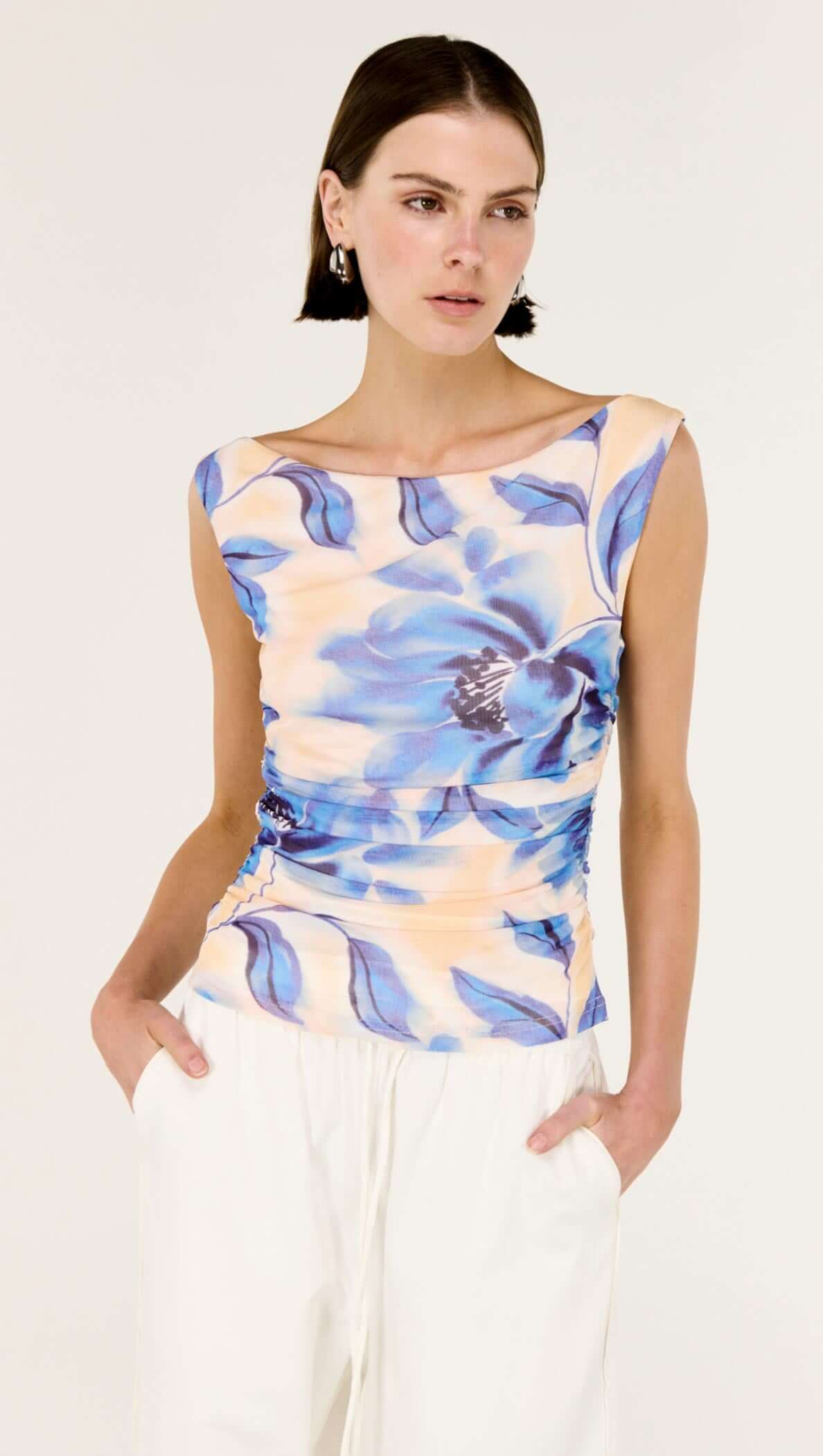 Model wearing a Blue Blurred Floral Mesh Top featuring a soft blue floral print and a body-skimming fit.