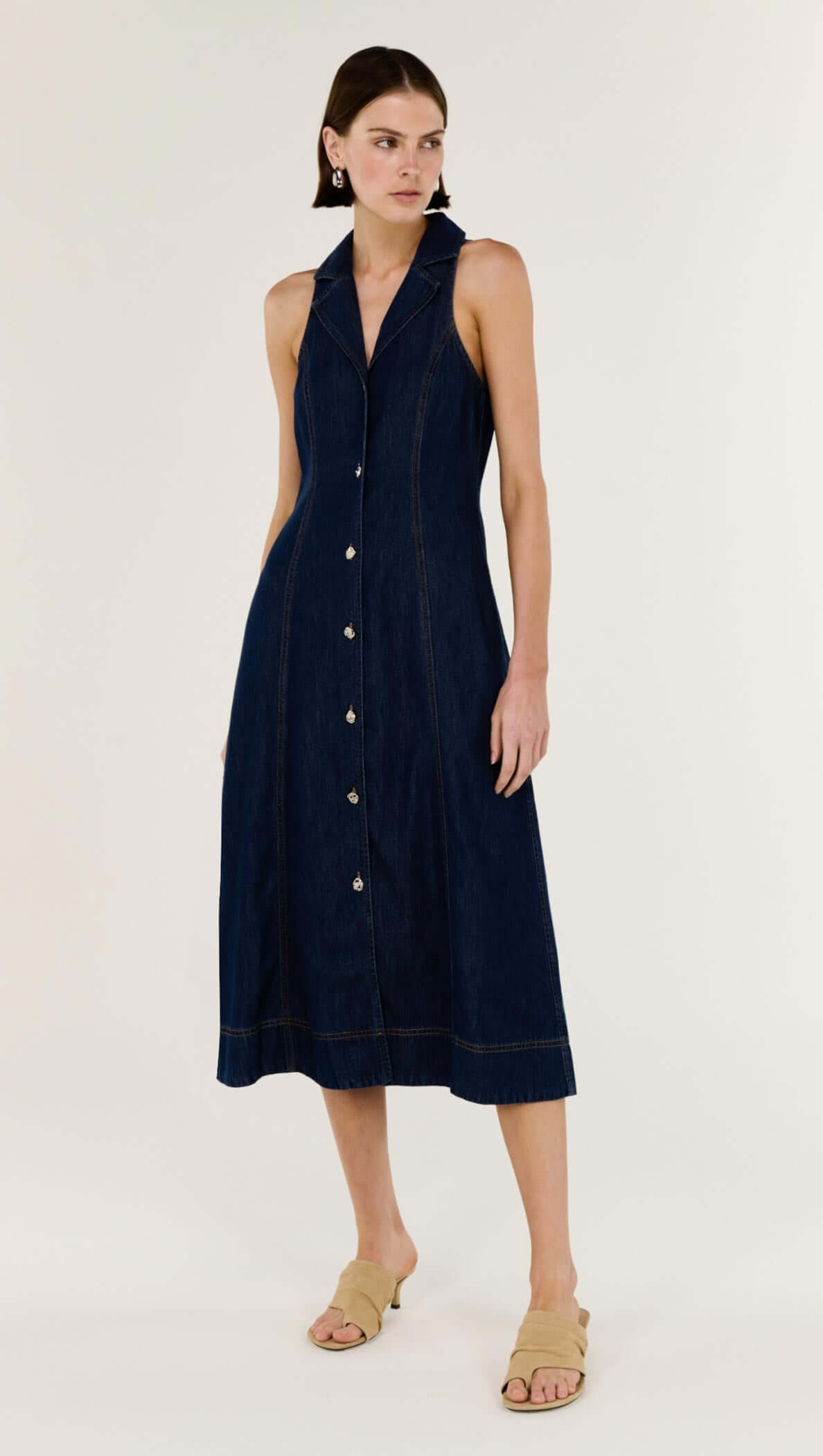 Denim Sleeveless Midi Shirt Dress showcasing structured indigo denim, sleeveless design, and button-through front.