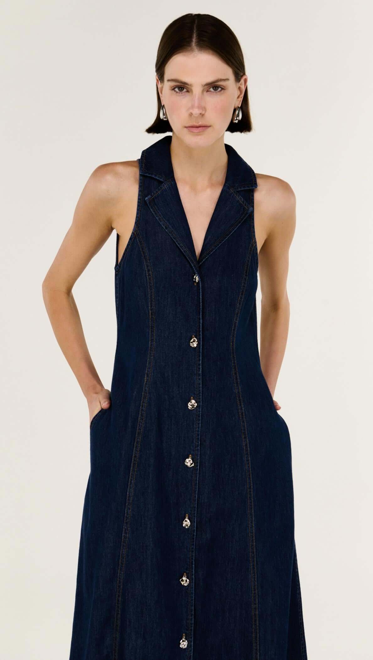 Denim Sleeveless Midi Shirt Dress showcasing structured indigo denim, sleeveless design, and button-through front.