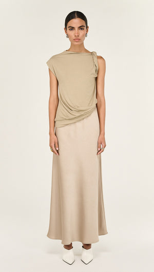 Model showcasing a Champagne Bias Cut Satin Maxi Skirt paired with a stylish top, creating a sophisticated outfit.