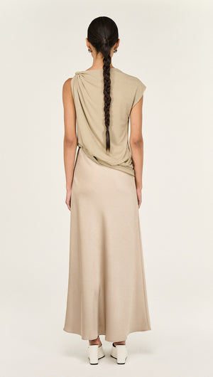 Back view of a model wearing a Champagne Bias Cut Satin Maxi Skirt styled with a sleeveless top.