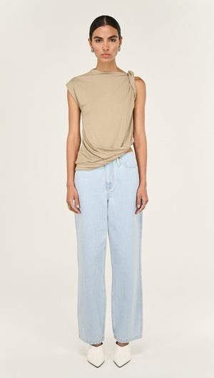 Model wearing Light Wash Straight Leg Denim Jeans paired with a beige top and white heels.