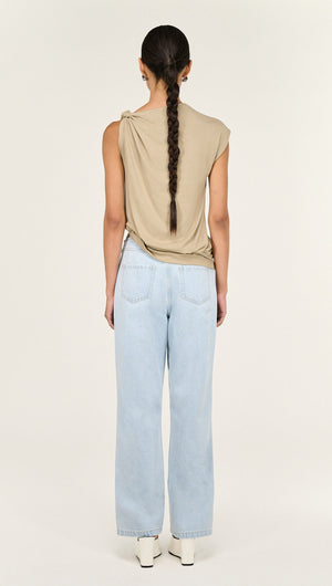 Model showcasing Light Wash Straight Leg Denim Jeans from the back, paired with a beige top.