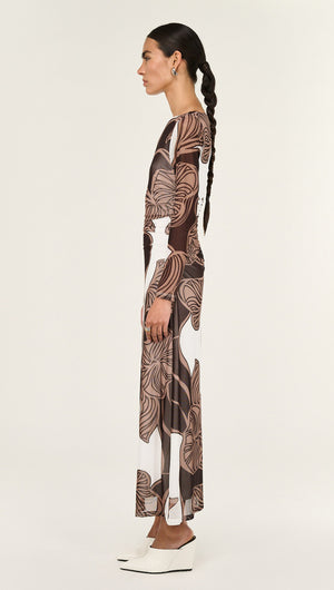 Side view of a woman wearing the Abstract Leaf Print Mesh Midi Dress with a bold, organic print.