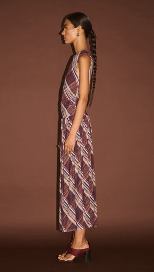 Plaid Mesh Midi Dress with Drop Waist shown in profile against a smooth brown background, showcasing its elegant design.