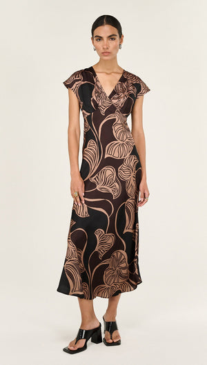 Abstract Leaf Print Bias Cut Midi Dress worn by a model showcasing its elegant design and flowing silhouette.