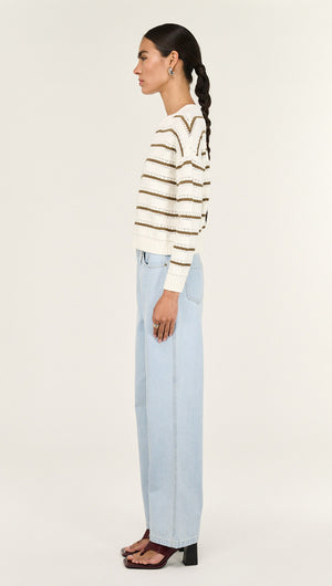 Khaki Stripe Round Neck Jumper side view, featuring soft fabric and stylish striped design, paired with light blue jeans.