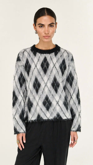 Relaxed Fit Argyle Brushed Jumper showcasing a black and white diamond pattern on a model.