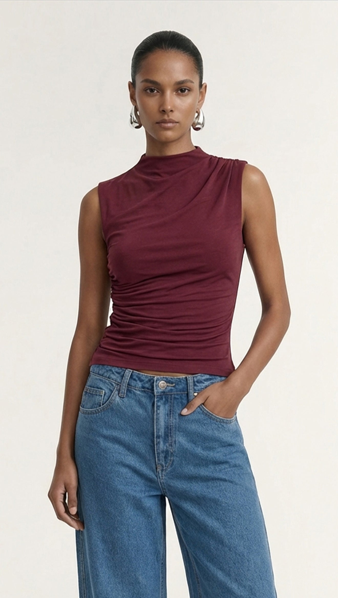 Burgundy High Neck Ruched Jersey Top worn by a model, showcasing its stylish fit and design.