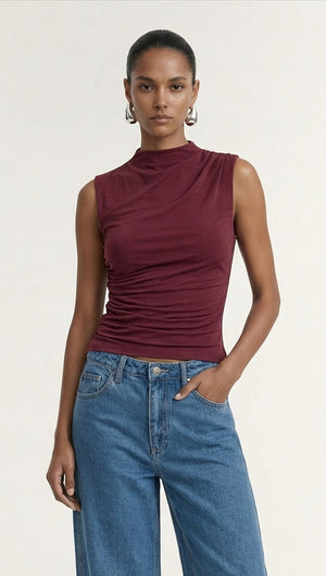 Burgundy High Neck Ruched Jersey Top worn by a model, showcasing its stylish fit and design.