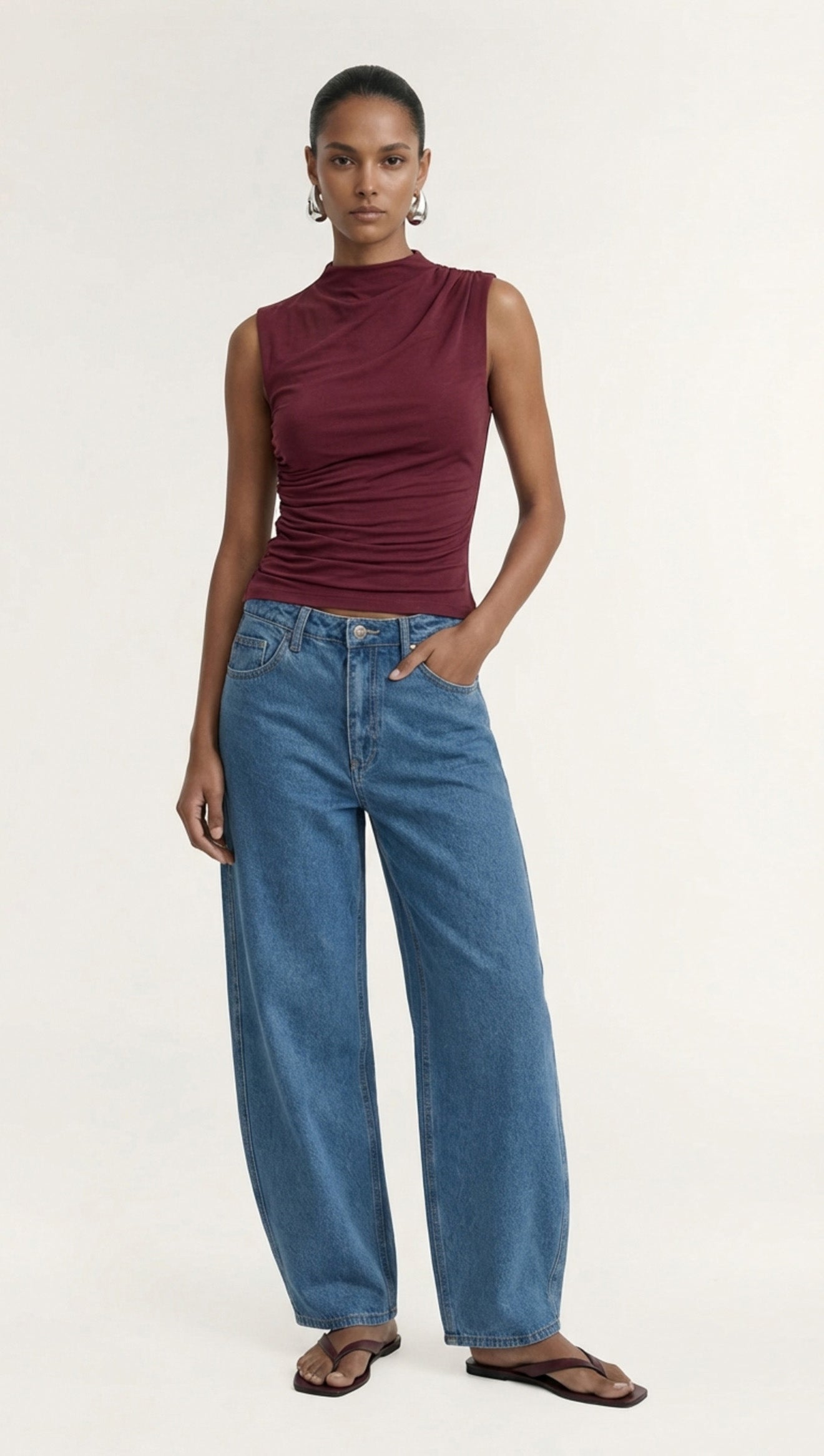 Burgundy High Neck Ruched Jersey Top worn by a model, showcasing its stylish fit and design.