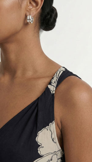 Close-up of a model wearing the Sketched Floral Mesh Midi Dress showcasing the floral design and elegant earrings.