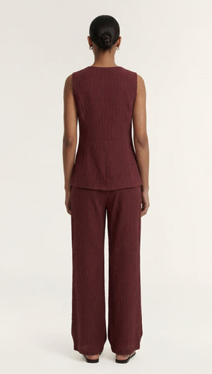 Back view of a model wearing a Burgundy Round Neck Textured Vest paired with matching wide-leg pants.