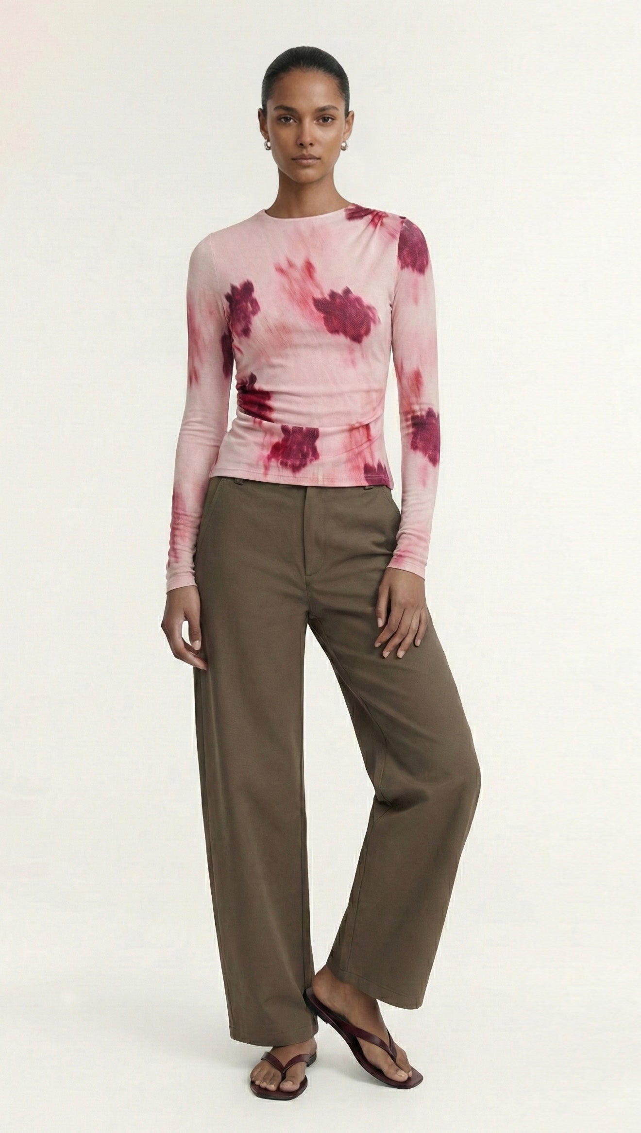 Pink Floral Mesh Long Sleeve Top worn with loose brown pants, showcasing a stylish and modern outfit.