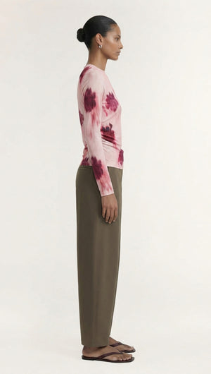 Model wearing a Pink Floral Mesh Long Sleeve Top paired with olive green pants, styled for a trendy look.