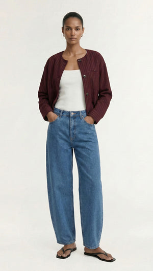 Model wearing a Burgundy Pinstripe Cropped Jacket with casual blue jeans and sandals.