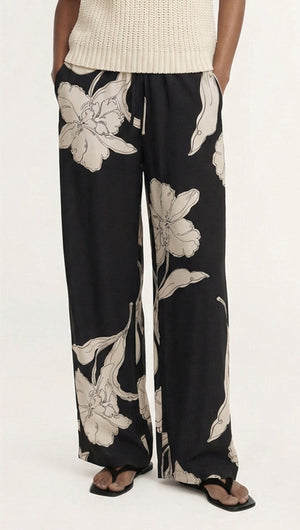 Model wearing Sketched Floral Drawstring Pant featuring a relaxed fit and floral pattern on a black background.