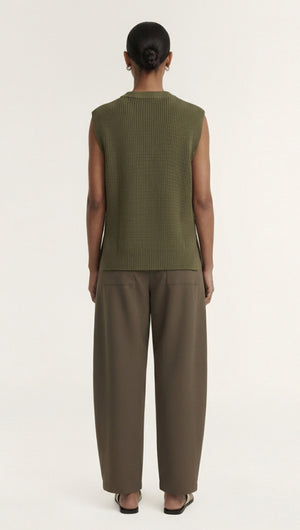 Back view of a model wearing a Khaki Cotton Blend Knit Tank Top paired with wide-leg pants.