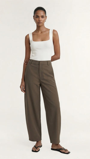 Model wearing Khaki Structured Barrel Leg Pant with a fitted white top and sandals, showcasing a stylish and modern look.