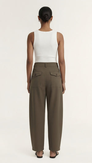 Back view of a model wearing Khaki Structured Barrel Leg Pant paired with a white tank top.