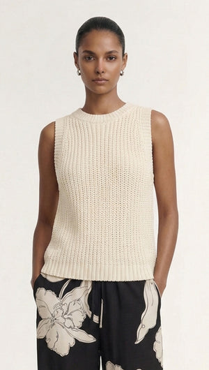 Beige Sleeveless Knit Tank Top worn by a model, featuring a textured knit design and styled with printed trousers.
